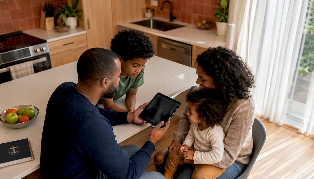 Family using telehealth app together in living room