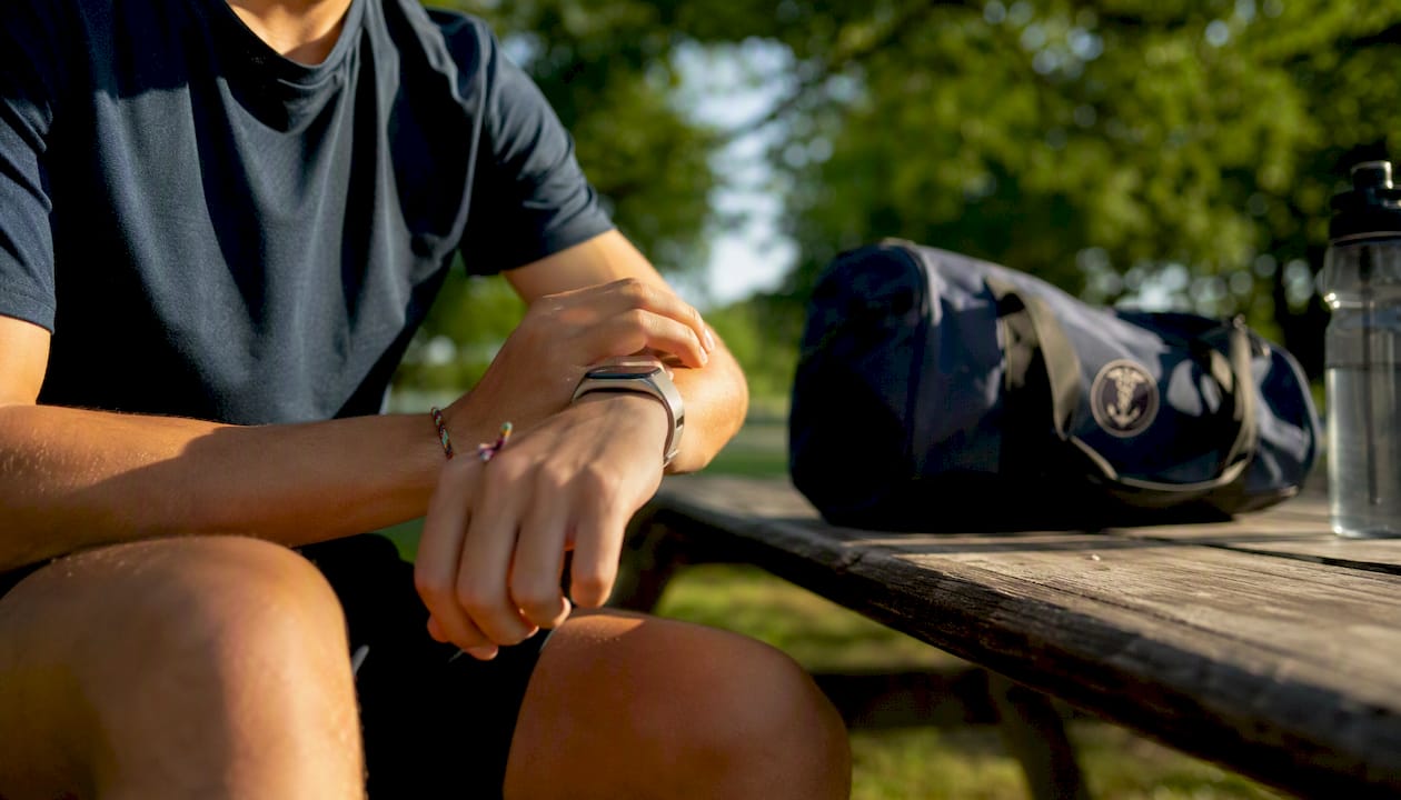 Athlete putting on fitness tracking wearable
