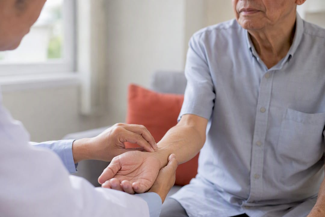 Clinician taking patient's wrist pulse